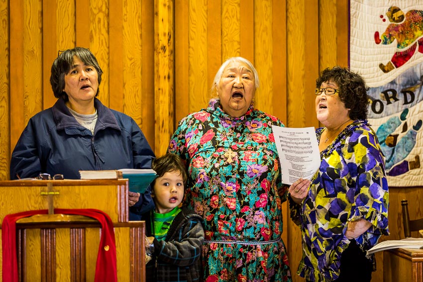Rev. Mary Ann Warden, second from right, leads her congregation in worship at the Kaktovik Presbyterian Church. They sing in both English and Inupiaq.