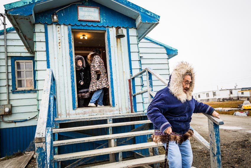 Issac Akootchook, 90 years old, walks home after church in Kaktovik.
